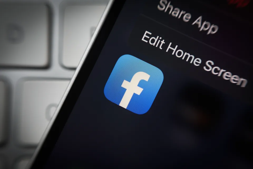 The Facebook logo is seen on an iPhone mobile device in this illustration photo in Warsaw, Poland on 12 October, 2022. (Photo by STR/NurPhoto via Getty Images)
