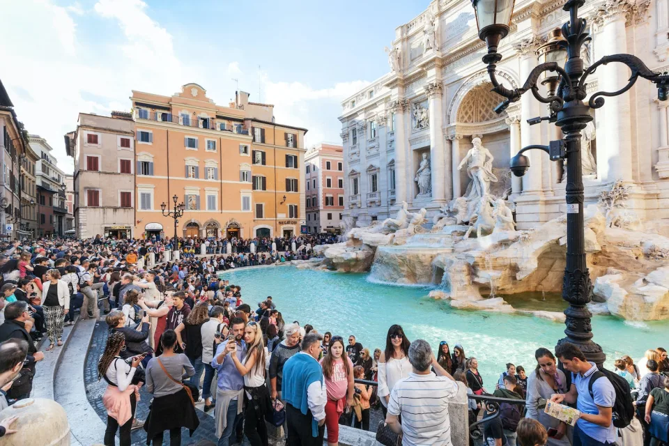 Tourists visit the Trevi Fountain in Rome, Italy.
